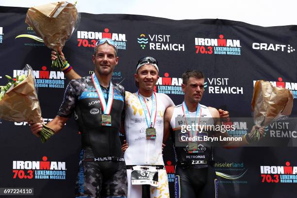 Bas Diederen of The Netherlands, Kenneth Vandendriessche of Belgium and Tim Brydenbach of Belgium stand on the podium after the Ironman 70.3...