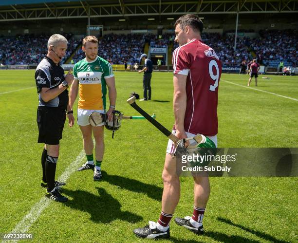Laois , Ireland - 18 June 2017; Referee Johnny Ryan with captains Seán Ryan of Offaly and David Burke of Galway during the coin toss ahead of the...