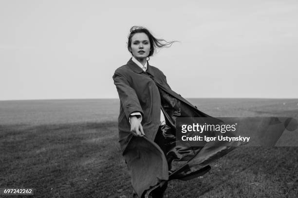 black and white portrait of woman in the field in coat - nature magazine 個照片及圖片檔