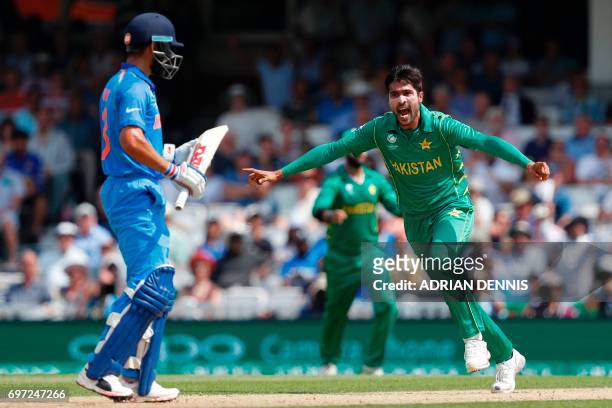 Pakistan's Mohammad Amir celebrates after taking the wicket of India's captain Virat Kohli during the ICC Champions Trophy final cricket match...