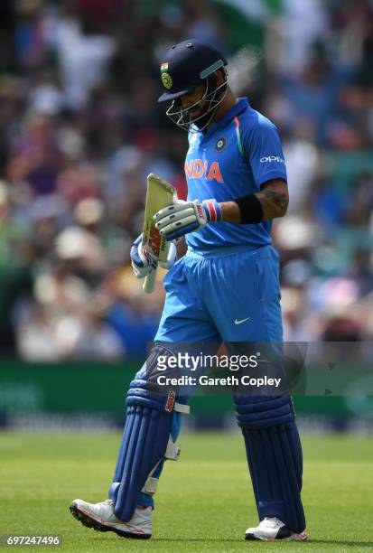 India captain Virat Kohli leaves the field after being dismissed Mohammad Amir of Pakistan during the ICC Champions Trophy Final between India and...