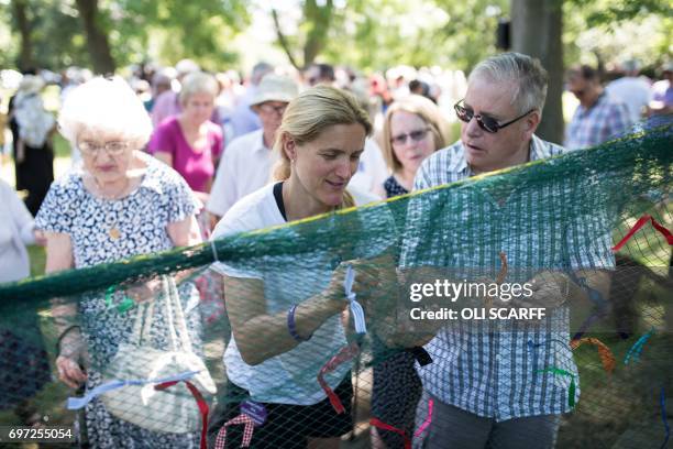 Kim Leadbeater , the sister of murdered Member of Parliament Jo Cox, joins others in symbolically tying a ribbon onto a piece of netting during a...