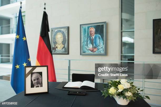 The book of condolence for former German Chancellor Helmut Kohl sits in front of a portrait of him at the Chancellery on June 18, 2017 in Berlin,...