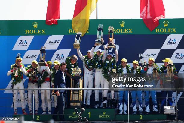 The overall winning The Porsche LMP Team 919 of Earl Bamber, Timo Bernhard and Brendon Hartley celebrate on the podium following the Le Mans 24 Hours...