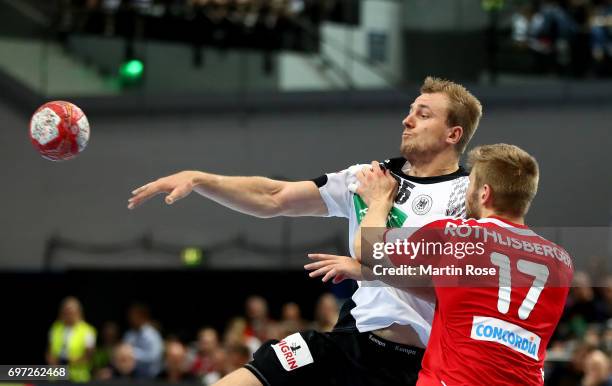 Kai Haefner of Germany challenges Samuel Roethlisberger of Switzerland during the 2018 EHF European Championship Qualifier between Germany and...