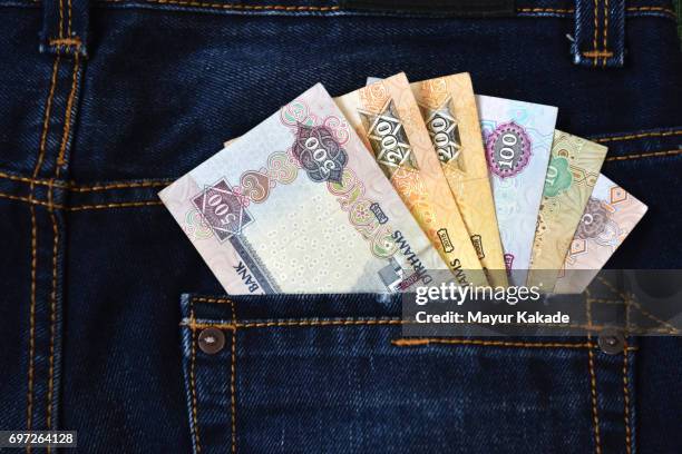 money in jeans back pocket - dirham stock pictures, royalty-free photos & images