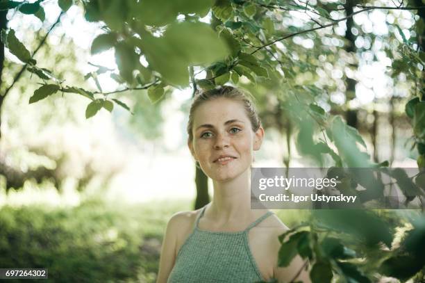 woman in the lush foliage in springtime - pale complexion stock-fotos und bilder