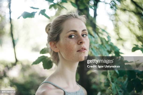 woman in the lush foliage in springtime - lightskinned stock pictures, royalty-free photos & images