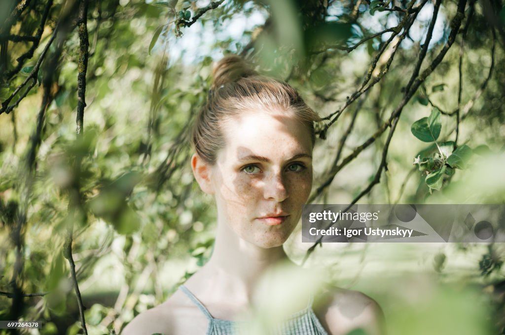 Woman in the lush foliage in springtime