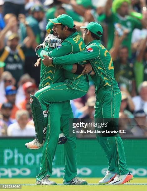 Sarfraz Ahmed of Pakistan congratulates Imad Wasim, after catching MS Dhoni of India during the ICC Champions Trophy Final between Pakistan and India...