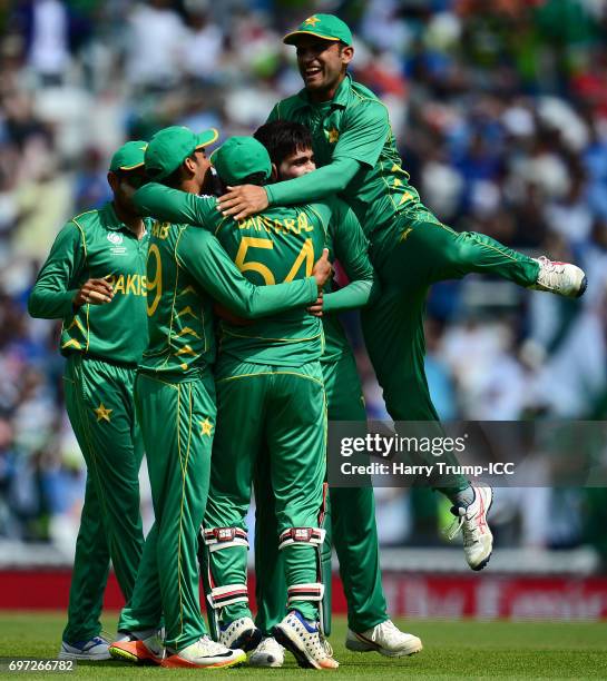 Mohammad Amir of Pakistan celebrates the wicket of Shikhar Dhawan of India with team mates during the ICC Champions Trophy Final match between India...