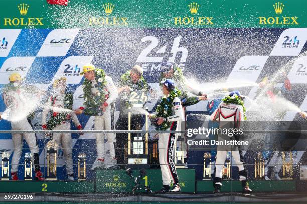 Brendon Hartley, Earl Bamber and Timo Bernhard of the Porsche LMP Team celebrate on the podium with Vice President of Porsche's LMP1 Racing Program,...