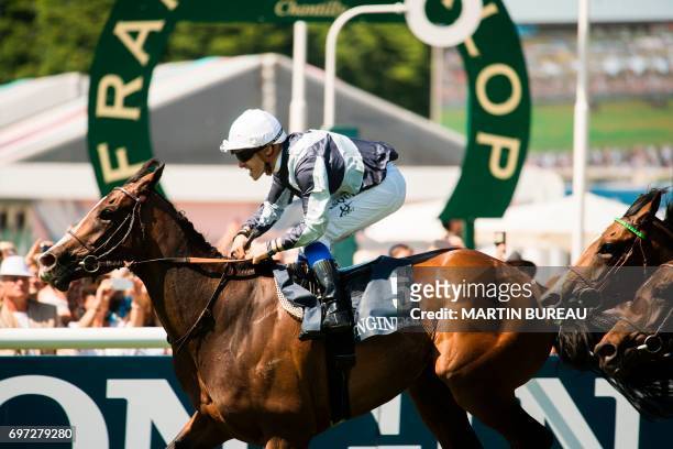 French jockey Stephane Pasquier rides his horse Senga as they cross the finish line and win the race of the Prix de Diane, a 2,100-meters flat horse...