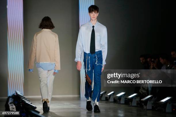 Model presents a creation for fashion house Sulvam during the Men's Spring/Summer 2018 fashion shows in Milan, on June 18, 2017. / AFP PHOTO / Marco...