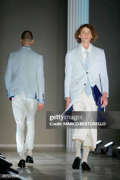 Model presents a creation for fashion house Sulvam during the Men's Spring/Summer 2018 fashion shows in Milan, on June 18, 2017. / AFP PHOTO / Marco...