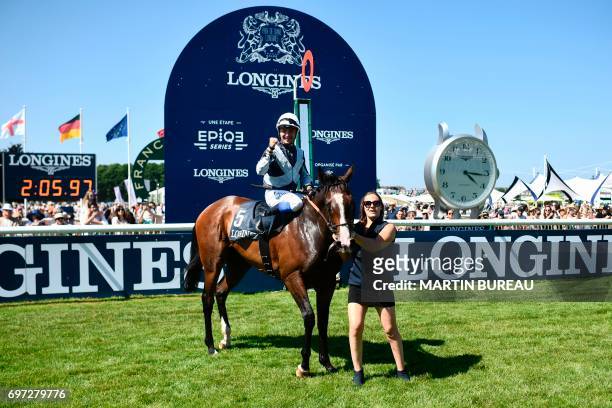 French jockey Stephane Pasquier celebrates as he poses for photographs with his horse Senga, after winning the Prix de Diane, a 2,100-meters flat...