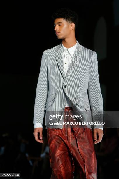 Model presents a creation for fashion house Sulvam during the Men's Spring/Summer 2018 fashion shows in Milan, on June 18, 2017. / AFP PHOTO / Marco...