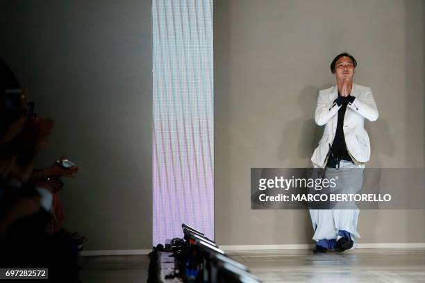 Designer Teppei Fujita greets the audience at the end of the show for fashion house Sulvam during the Men's Spring/Summer 2018 fashion shows in...