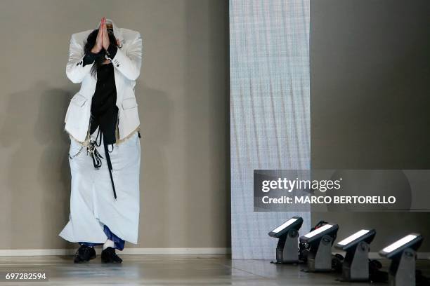 Designer Teppei Fujita greets the audience at the end of the show for fashion house Sulvam during the Men's Spring/Summer 2018 fashion shows in...