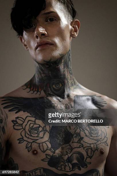 Model wearing tattoos is pictured backstage before the show for fashion house Sulvam during the Men's Spring/Summer 2018 fashion shows in Milan, on...
