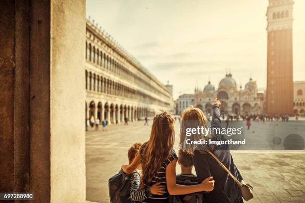 mother and kids tourists at piazza san marco in venice - campanile venice stock pictures, royalty-free photos & images