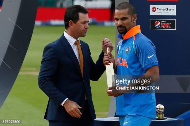 India's Shikhar Dhawan receives the Golden Bat for the top run-scorer from former Australia captain Ricky Ponting after the ICC Champions Trophy...
