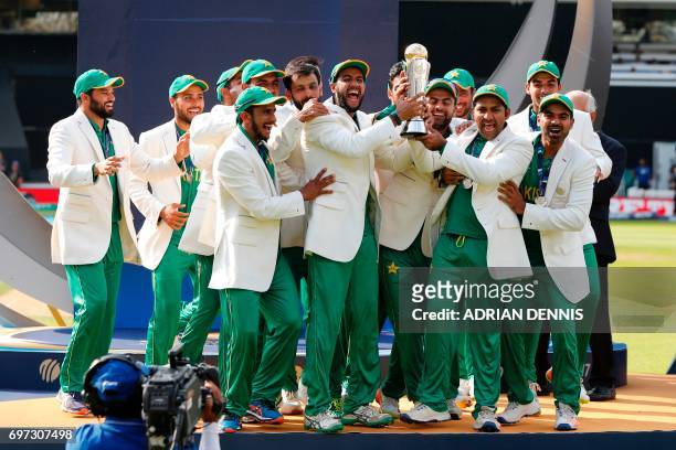 Pakistan's Sarfraz Ahmed lifts the trophy as Pakistan players celebrate their win at the presentation after the ICC Champions Trophy final cricket...