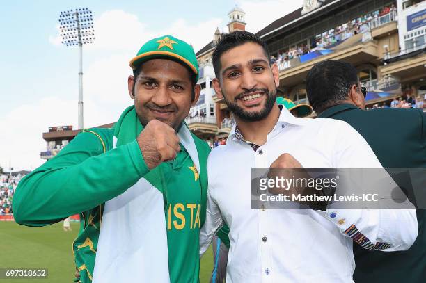 Sarfraz Ahmed of Pakistan celebrates his teams win, with boxer Amir Khan after beating India during the ICC Champions Trophy Final between Pakistan...
