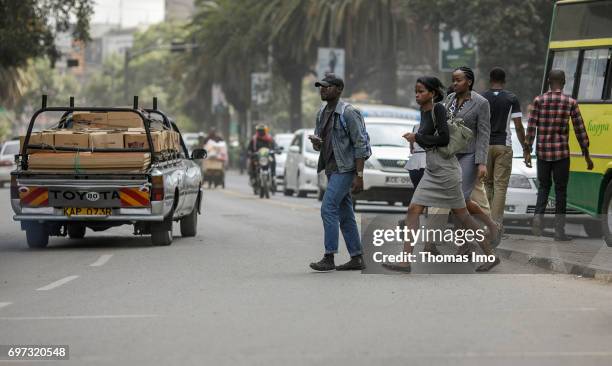 Nairobi, Kenya Pedestrians cross a street. Street scene in Nairobi, capital of Kenya on May 15, 2017 in Nairobi, Kenya.