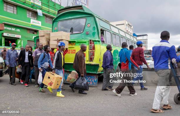 Nairobi, Kenya African men are coming out of a bus. Street scene in Nairobi, capital of Kenya on May 15, 2017 in Nairobi, Kenya.