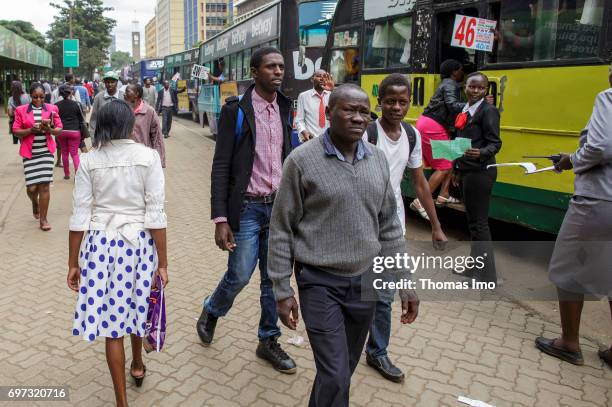 Nairobi, Kenya Pedestrians at a bus stop. Street scene in Nairobi, capital of Kenya on May 15, 2017 in Nairobi, Kenya.