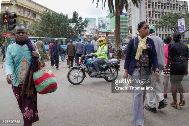 Nairobi, Kenya Pedestrians cross a street. Street scene in Nairobi, capital of Kenya on May 15, 2017 in Nairobi, Kenya.