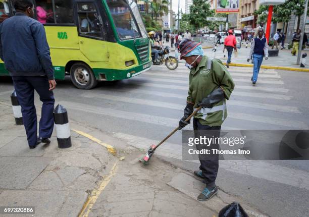 Nairobi, Kenya A worker cleans a road. Street scene in Nairobi, capital of Kenya on May 15, 2017 in Nairobi, Kenya.