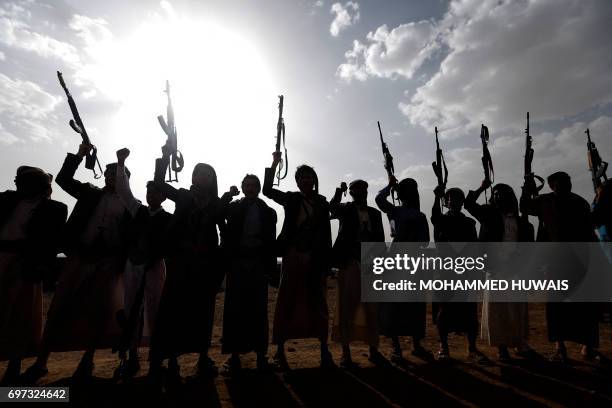 Yemen's Shiite Huthi rebels shout slogans during a gathering to mobilise more fighters to battlefronts to fight pro-government forces, on June 18 in...