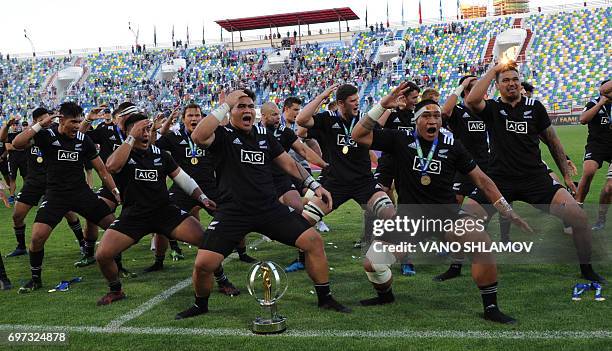 New Zealand's players perform the Haka next to the trophy after winning the 2017 World Rugby U20 Championship final match against England at...