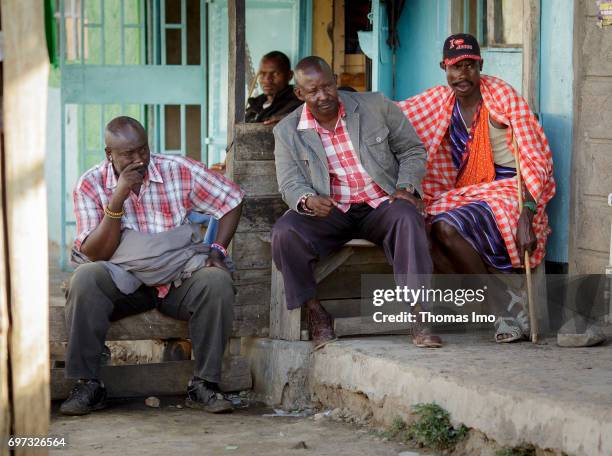 Talek, Kenya Four African men sitting in front of a house. Street scene in Talek on May 17, 2017 in Talek, Kenya.