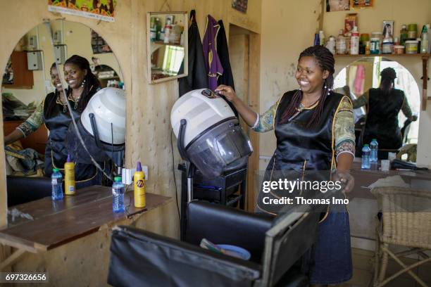 Talek, Kenya Portrait of the hairdresser Emma Kinyanjui, operator of a barber and cosmetic salon, at work on May 17, 2017 in Talek, Kenya.