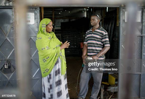 Talek, Kenya Fatuma Aden, owner of the welding shop Al-Tawakal, in conversation with an employee on May 17, 2017 in Talek, Kenya.