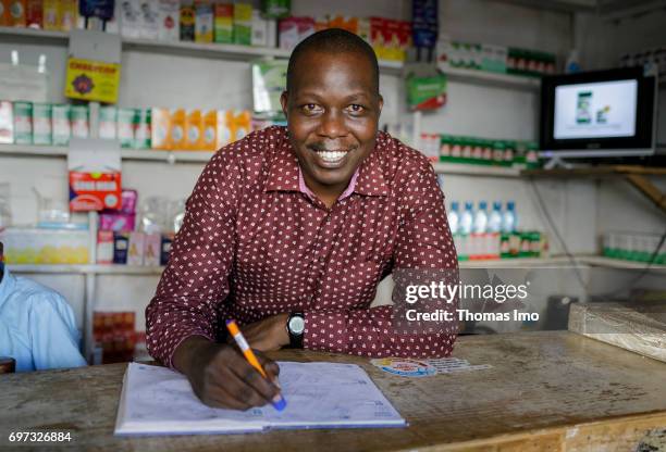 Talek, Kenya Portrait of Joshua Saitozi, owner of a pharmacy, at work on May 17, 2017 in Talek, Kenya.