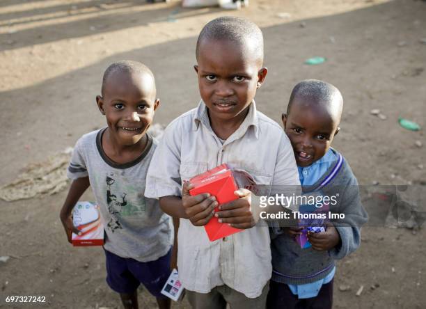 Talek, Kenya 3 boys posing in front of the camera on a market on May 17, 2017 in Talek, Kenya.