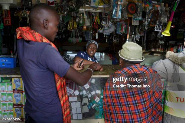 Talek, Kenya A saleswoman of a shop for household goods is talking to two customers on May 17, 2017 in Talek, Kenya.