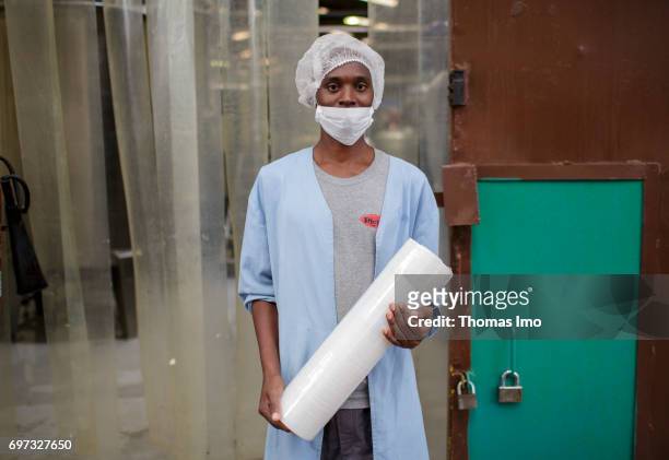 Thika, Kenya Portrait of an African worker with hairnet and mouthguard. Production of pineapple juice at beverages manufacturer Kevian Kenya Ltd. On...