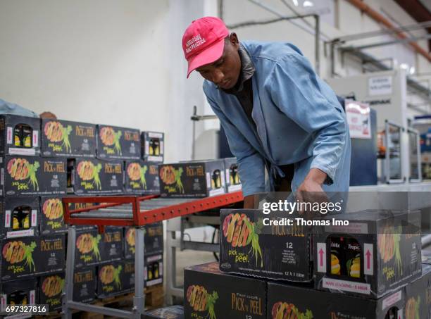 Thika, Kenya An African worker is stacking tetrapacks in a warehouse. Production of juice at beverage manufacturer Kevian Kenya Ltd. On May 18, 2017...