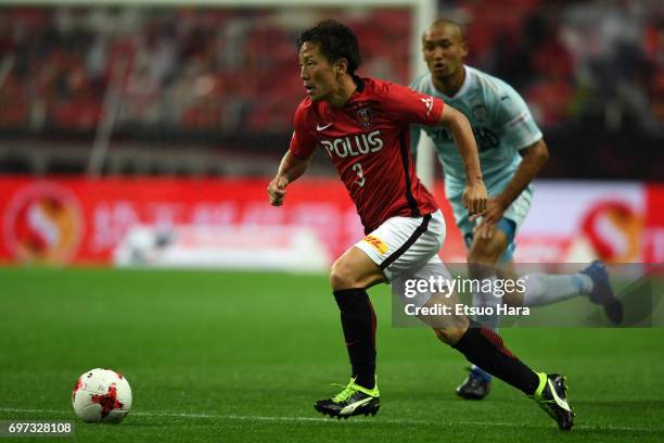 Tomoya Ugajin of Urawa Red Diamonds in action during the J.League J1 match between Urawa Red Diamonds and Jubilo Iwata at Saitama Stadium on June 18,...