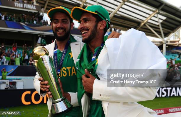 Imad Wasim and Hassan Ali of Pakistan celebrate with the trophy during the ICC Champions Trophy Final match between India and Pakistan at The Kia...