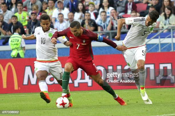 Cristiano Ronaldo of Portugal in action against Giovani Dos Santos end Diego Reyes of Mexico during the FIFA Confederations Cup 2017 group A soccer...