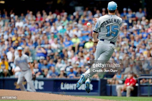 Cory Spangenberg of the San Diego Padres commits a throwing error as he throws to first base on a ball hit by Eric Sogard of the Milwaukee Brewers...