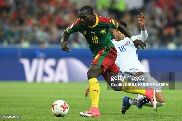 Cameroon's forward Vincent Aboubakar advances with the ball past Chile's defender Gonzalo Jara during the 2017 Confederations Cup group B football...