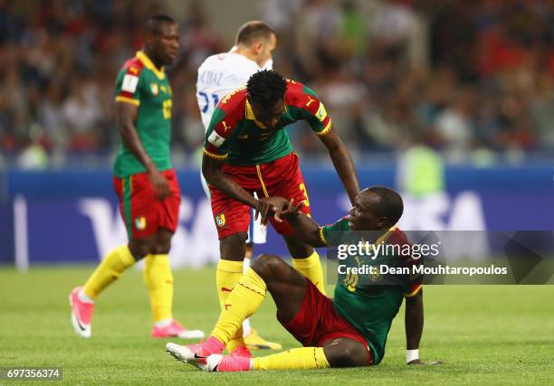 Andre Zambo of Cameroon helps Vincent Aboubakar of Cameroon up during the FIFA Confederations Cup Russia 2017 Group B match between Cameroon and...