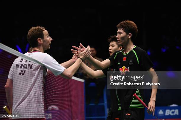 Li Junhui and Liu Yuchen of China greet Mathias Boe and Carsten Mogensen of Denmark during Men's Double Final match of the BCA Indonesia Open 2017 at...
